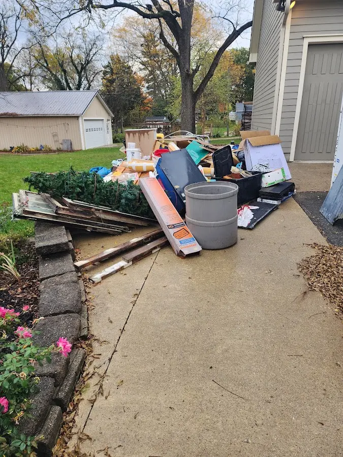 Dumpster being loaded with debris for Roofing Dumpster Rental in Webb City